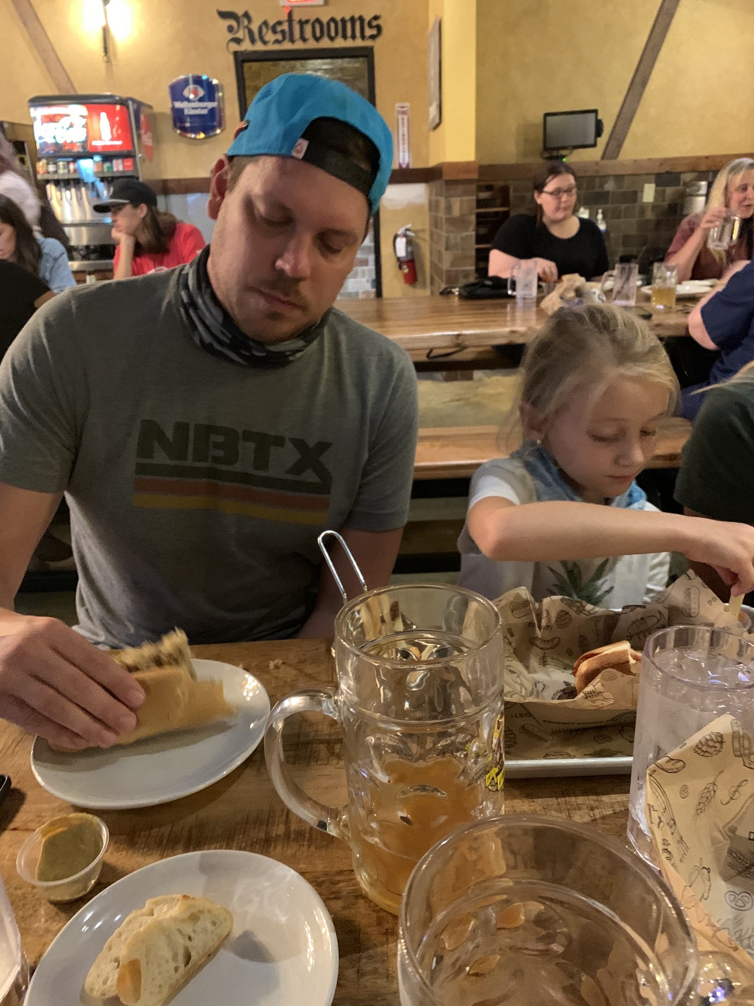 Friends raising beer steins together at a restaurant table